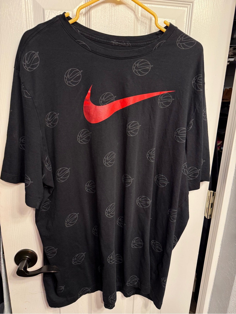 Nike Black Short-Sleeve Tee with Red Swoosh and Subtle Basketball Print